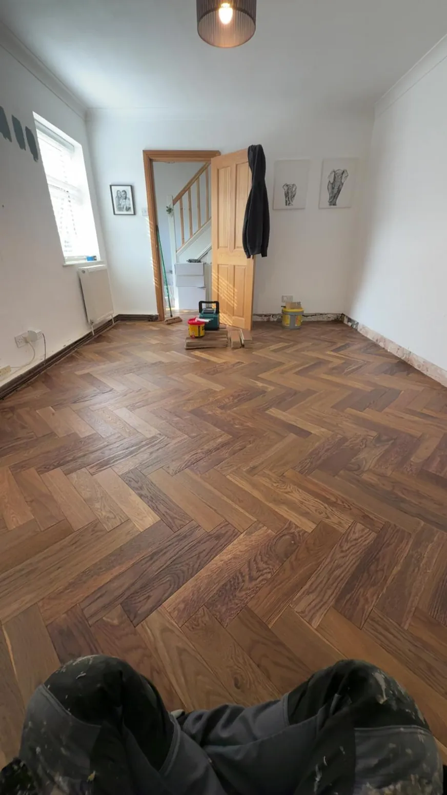 Herringbone timber flooring in a bright refurbished room