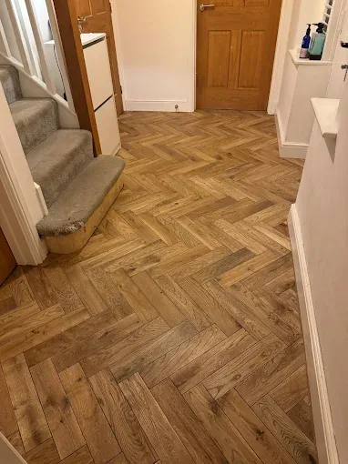 Warm-toned parquet-style floor in domestic hallway