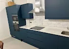 Blue kitchen units, matching cupboards and integrated appliances