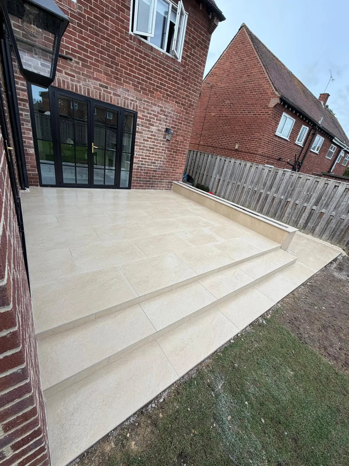 Completed light porcelain terrace with wide shallow steps