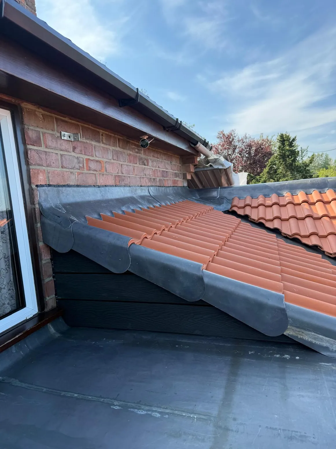 New roof tiles and weatherproofing around roof junction